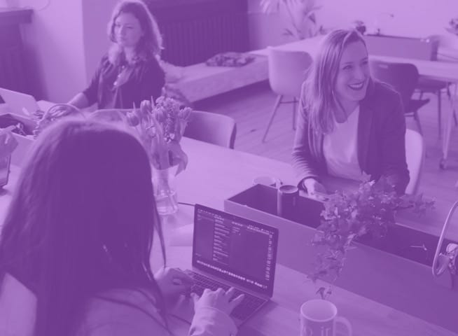 group of women working on laptops